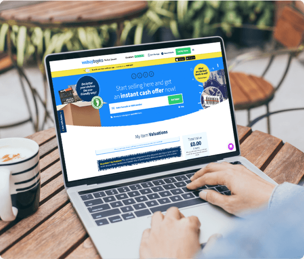 Laptop on outdoor table showing WeBuyBooks site with instant cash offer and item valuation form