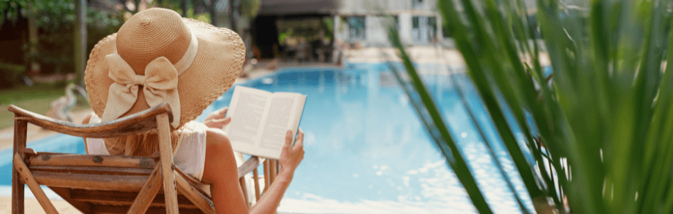 Woman reading a book by the pool.png