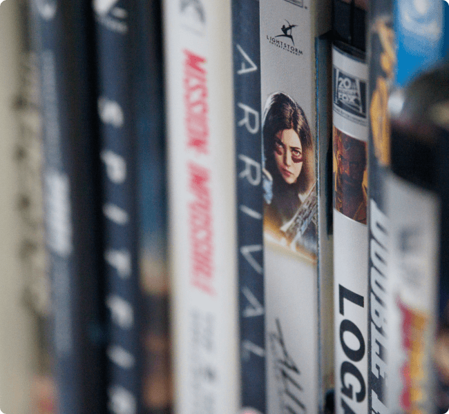 Row of DVDs including Mission Impossible, Arrival and Logan, part of a film collection to sell