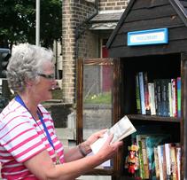 A local community member making the most of the We Buy Books Free Little Library