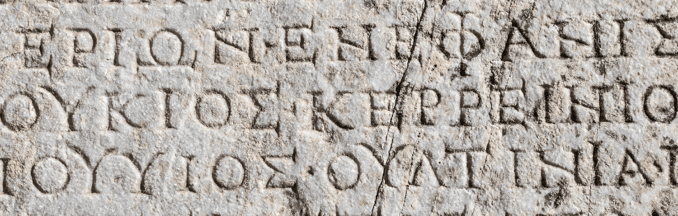Ancient Greek script carved into stone.png