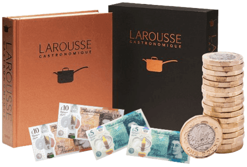 Larousse Gastronomique cookbooks beside a stack of pound coins and UK banknotes, showing cash paid for cookbooks