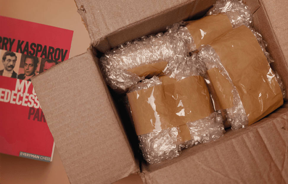 Cardbpard box full of books wrapped in bubble wrap and tape.png