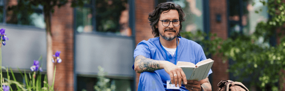 Doctor taking a break from work reading a book.png