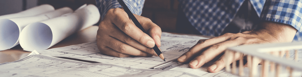 Man drawing architecure plans.png