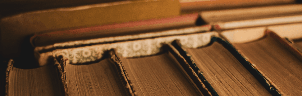 Row of old leather-bound books.png