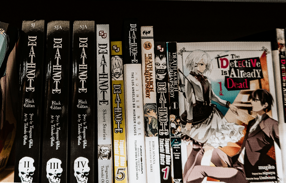 Shelf containing multiple copies of Death Note Manga.png
