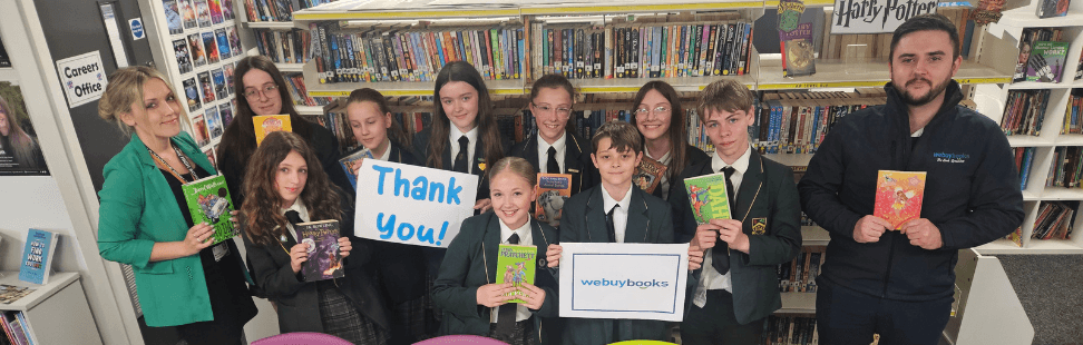 Students of Colne Park High School holding books donated to the school.png