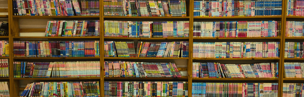 Thousands of comic books neatly aligned on shelves.png