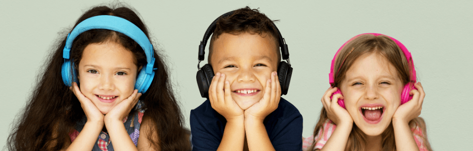 Three children listening to their Tonieboxes with headphones.png