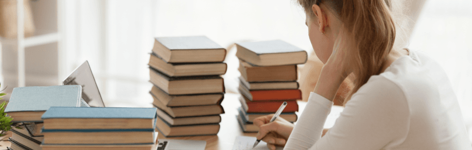 Woman selling piles of secondhand books from home.png