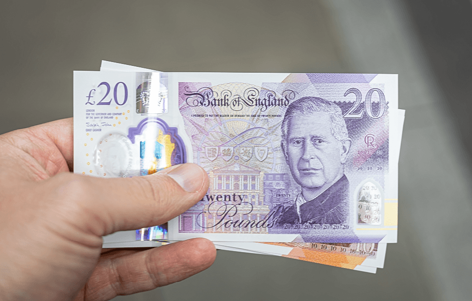 hand hold a collection of £20 notes.png